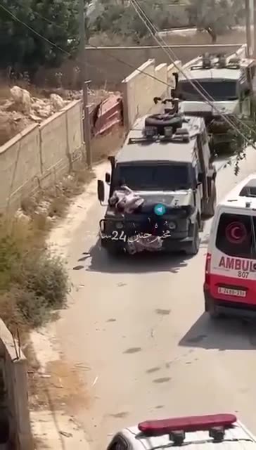 Demonic Israeli terrorists strap an unarmed Palestinian civilian to the hood