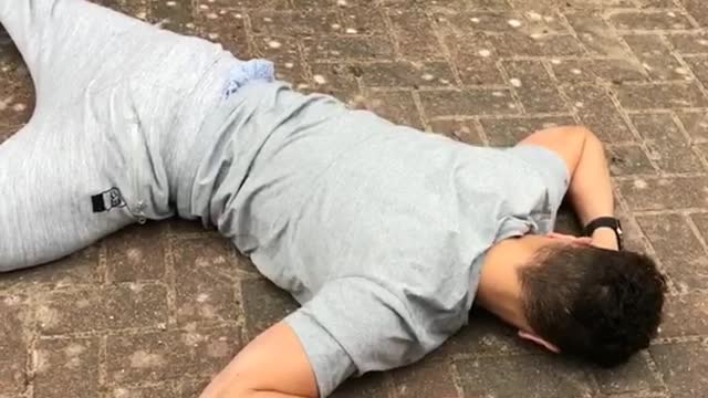 Grey sweatpants on skateboard falls down on sidewalk