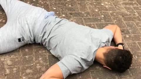 Grey sweatpants on skateboard falls down on sidewalk