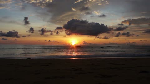 Watch the sunset footage of the sun on the beach.