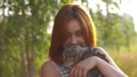 woman with scottish-fold cat outside