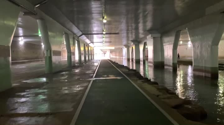 moving forward under a concrete bridge along a river