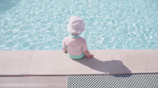 Baby Moments Playing With Water in pool