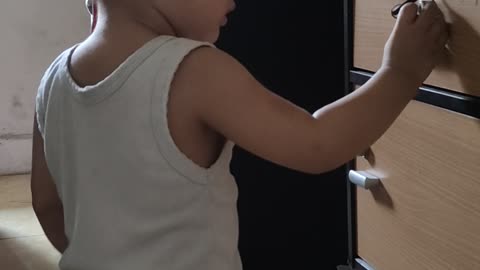 cute baby trying to put the key in the keyhole