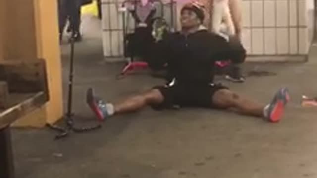 Guy pink shirt yellow body suit on unicorn singing running subway