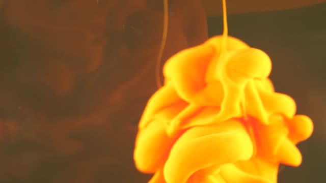 Yellow ink falling through water