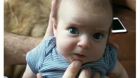 Baby makes funny weird faces.