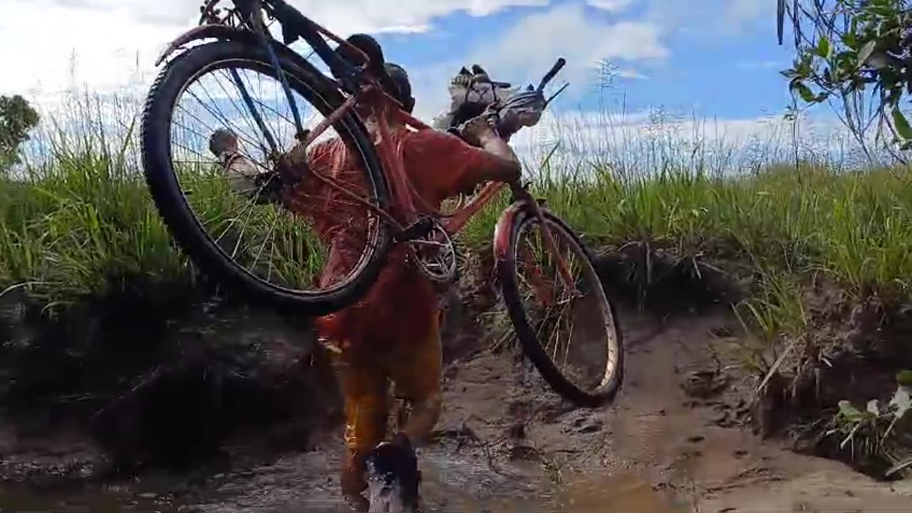 Guyana: Frontline Missions Hewlete David takes bike and motorcycle across river on Christian mission trip.