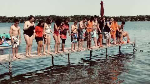 Youth Group Jumping In To A Lake