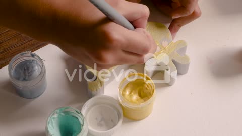 Close Up View Of Girl's Hands Painting Animal Pieces On The Floor 1