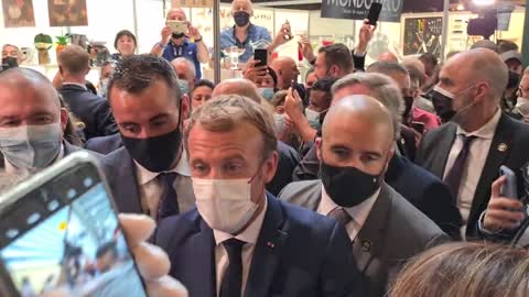 Macron hit in the face with an egg.