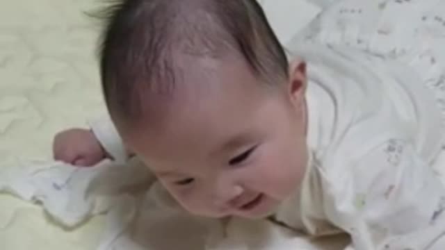 Baby laughing at the sound of balloons