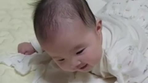 Baby laughing at the sound of balloons