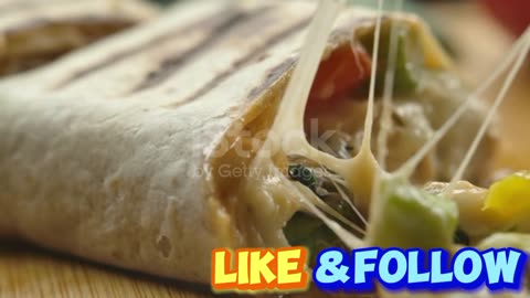 Super close-up of mexican burrito with melted cheese and Juicy pieces of meat