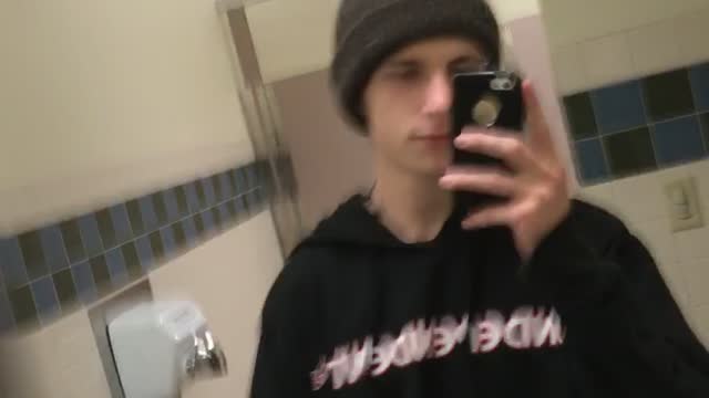 Guy green beanie runs into wall in bathroom