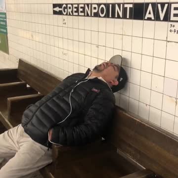 Man falls asleep on subway station bench and snores loudly