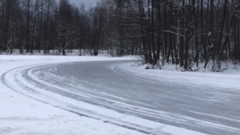 Group of Cars Slide Around Icy Corner