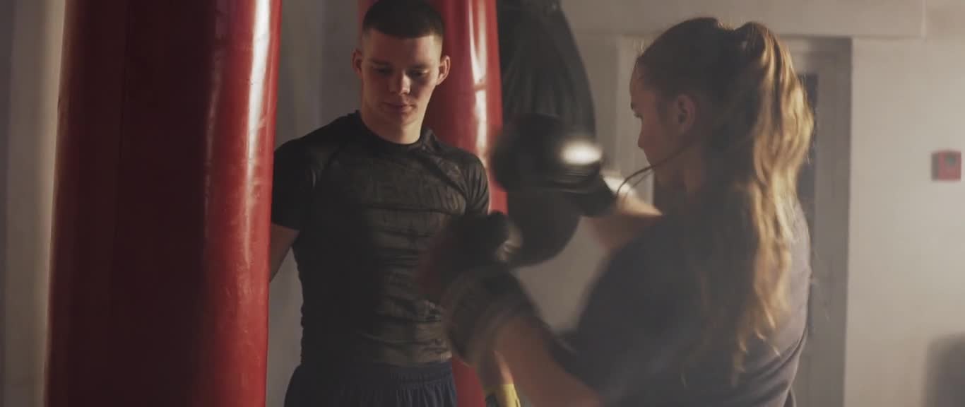 Woman Training With Punching Bag