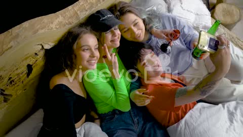 Young Friends Taking Pics On Bed While Drink Alcohol