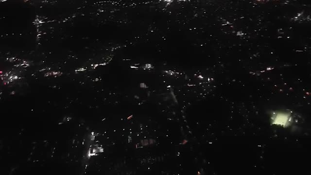On the plane. Night flight. City from the sky.