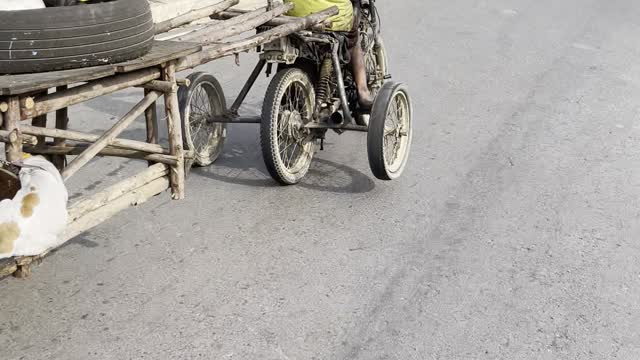 Motorcycle With Many Wheels Cruises Along Street