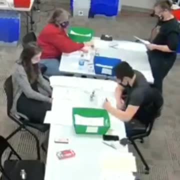 Poll Worker Filling Out Ballots