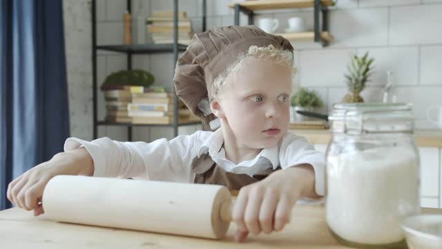 Cute baby practicing how to bake