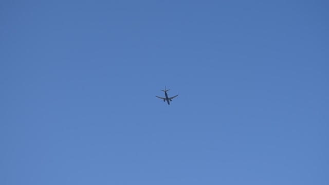 Plane in the blue sky from takeoff