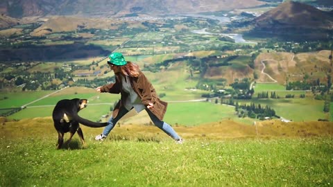 woman playing with dog