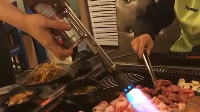 Flame thrower in barbecue restaurant