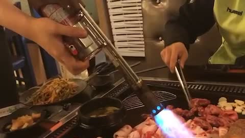 Flame thrower in barbecue restaurant