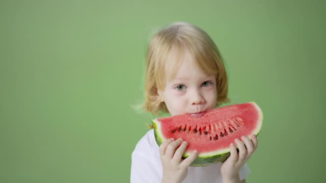 The child is eating watermelon