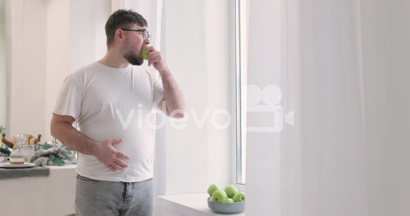 Boy Picking An Apple From A Fruit Bowl And Then He Eats It