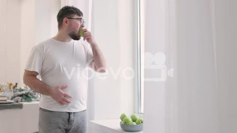Boy Picking An Apple From A Fruit Bowl And Then He Eats It