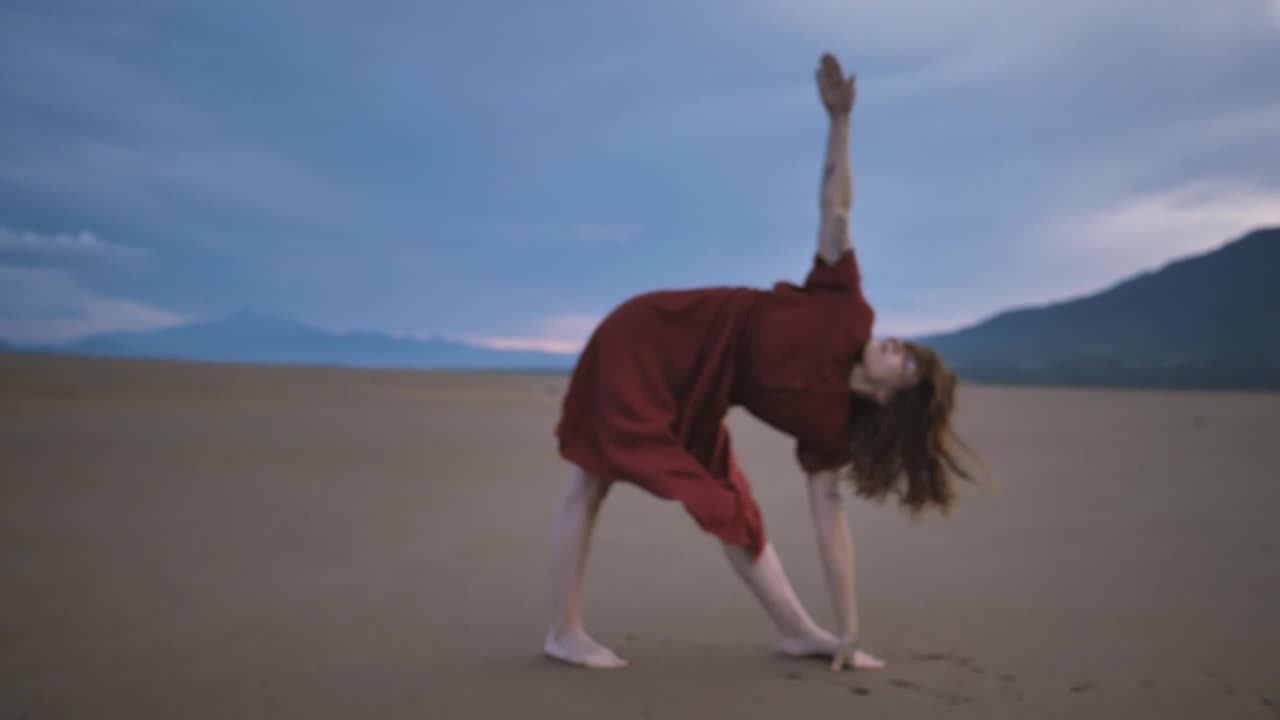 Woman stretching her body while doing yoga in the desert