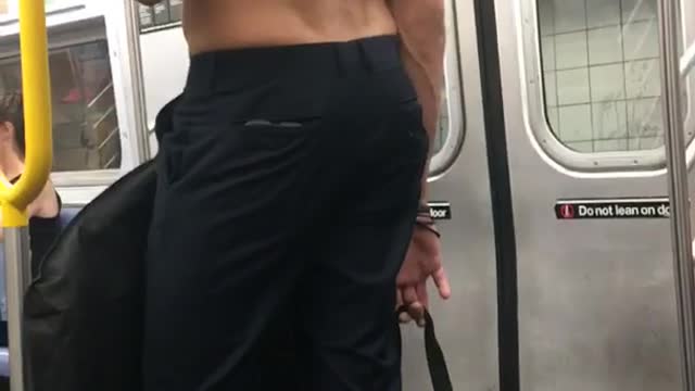 Shirtless man blue pants long hair