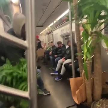 He walks with the flowers in the subway