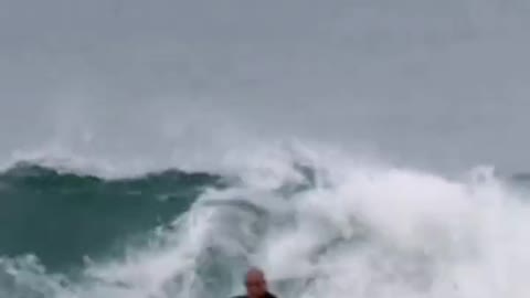 Handsome guy challenges surfing