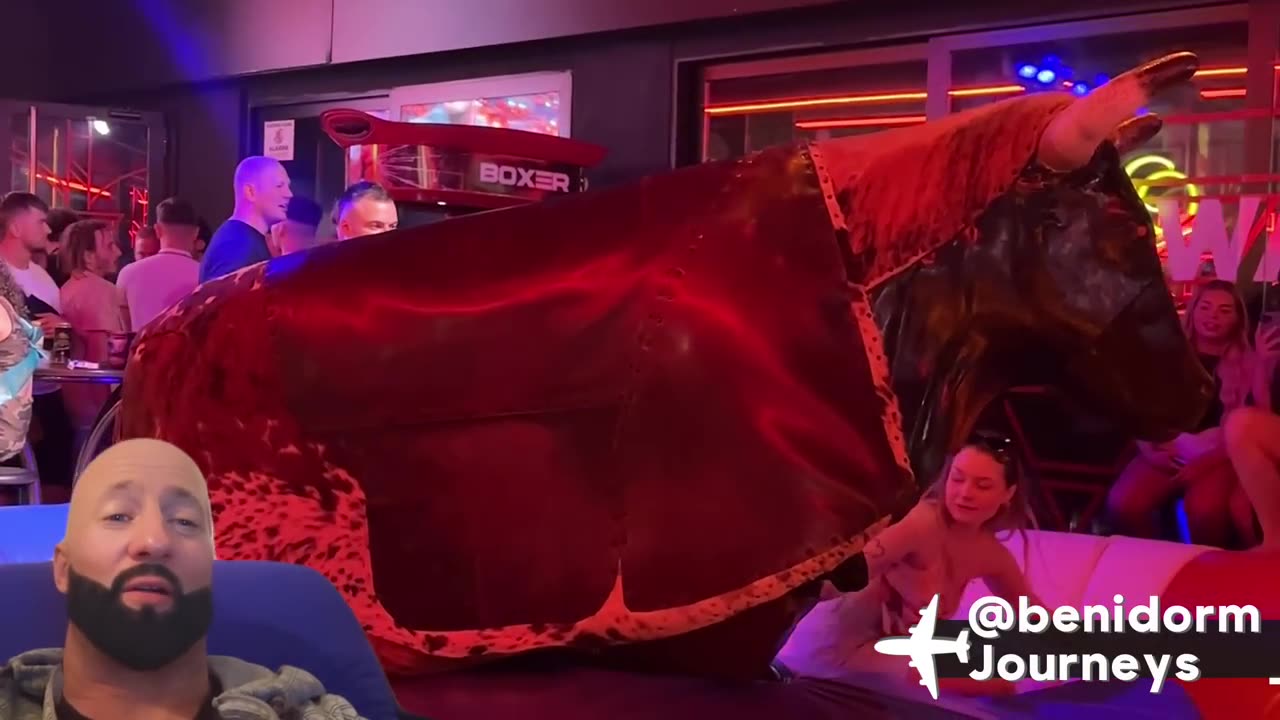 Cool Blonde Girl Riding on a Bull in Benidorm 4K