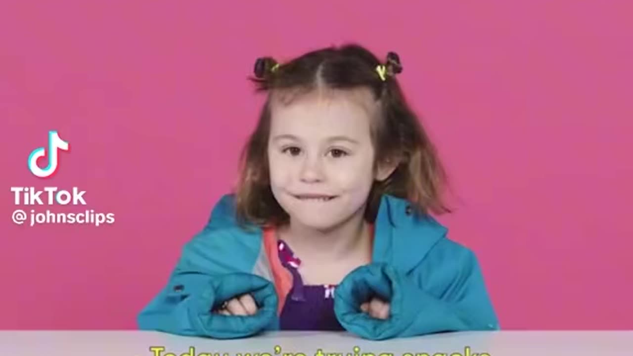 Young kids try snacks from Pakistan.