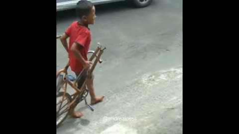 a little boy cut his bicycle into 2 halves