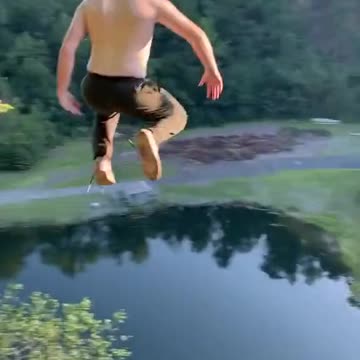 Brave guy jumps off a cliff into water