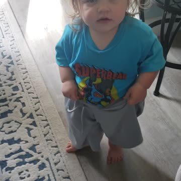 My baby girl wearing brothers shorts