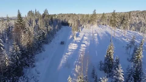 Car Driving Snowy Road Winter Forest Trees Drone HQ