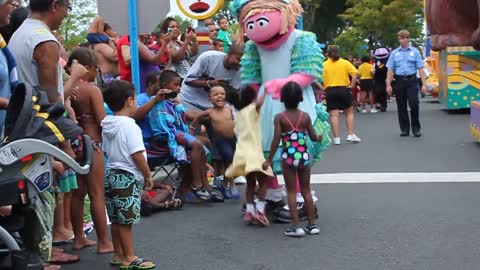 Sesame Place character interacts with adorable black children