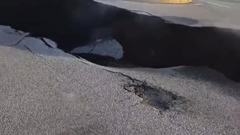 Massive crack emanating steam in Grindavik town of Iceland from a potential volcanic eruption