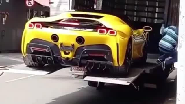 Half a million dollar car falls off the loading truck