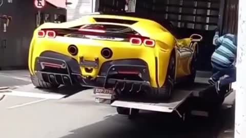 Half a million dollar car falls off the loading truck