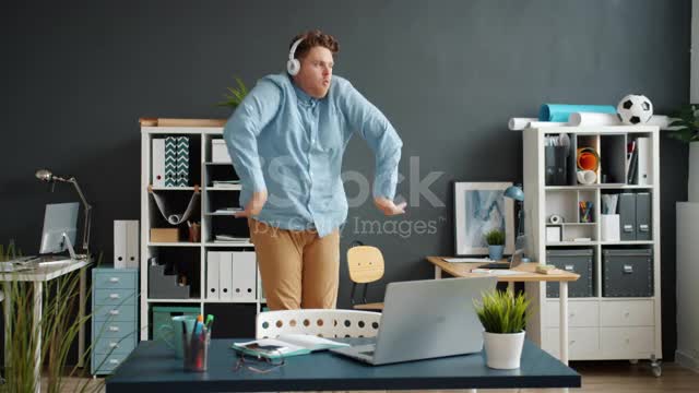 Slow motion of funny employee dancing in office room