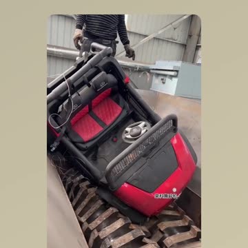 Sad end of the electric toy car in the industrial shredder